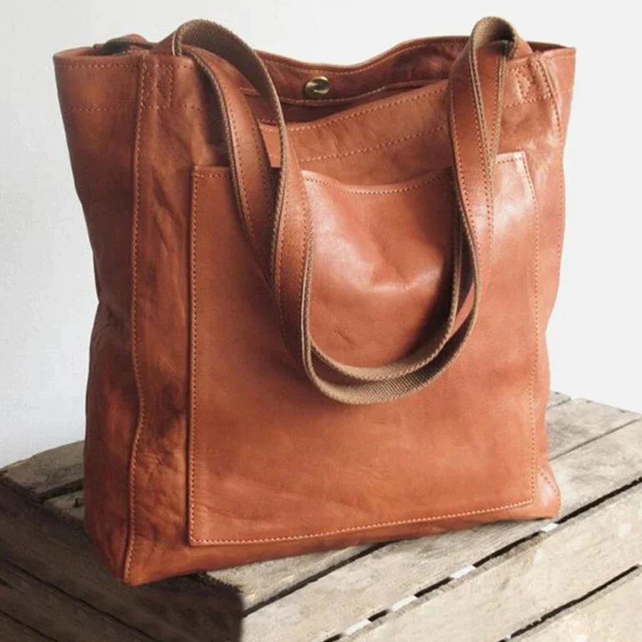 Side view of women's stylish leather shoulder bag showing strap drop and gusset design