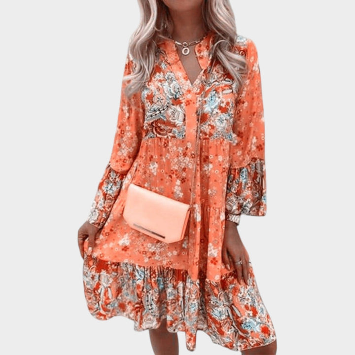 Back view of a women's floral boho mini dress with V-neck and tiered design for summer