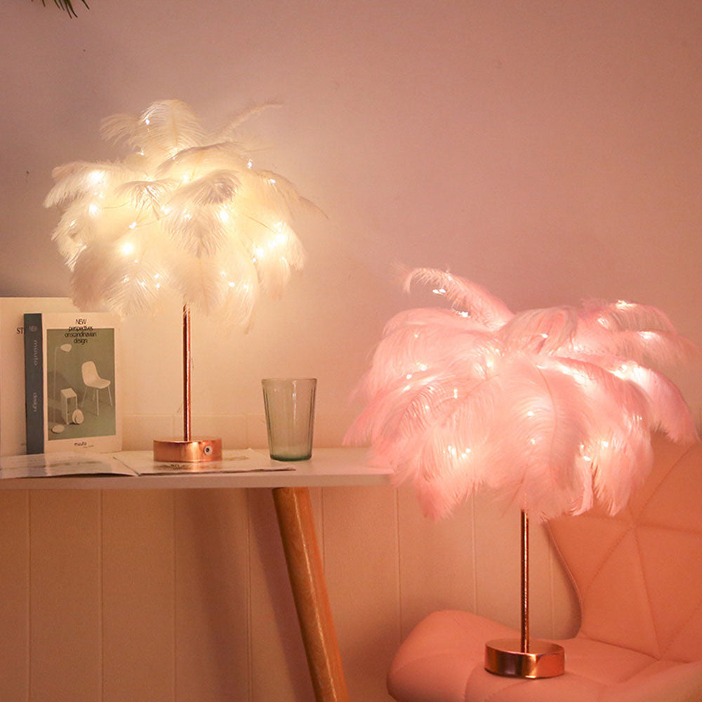 White and pink feather night lights illuminating a stylish desk setup