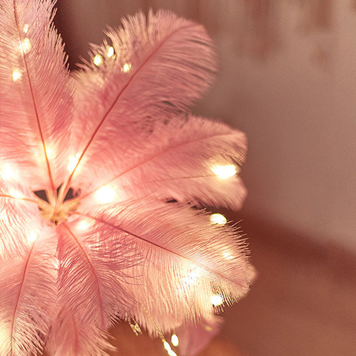 Aesthetic bedroom lighting accessory with fluffy feathers and a chic metallic base