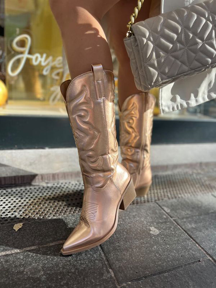 Angled shot of reflective metallic boots highlighting the classic pull tabs