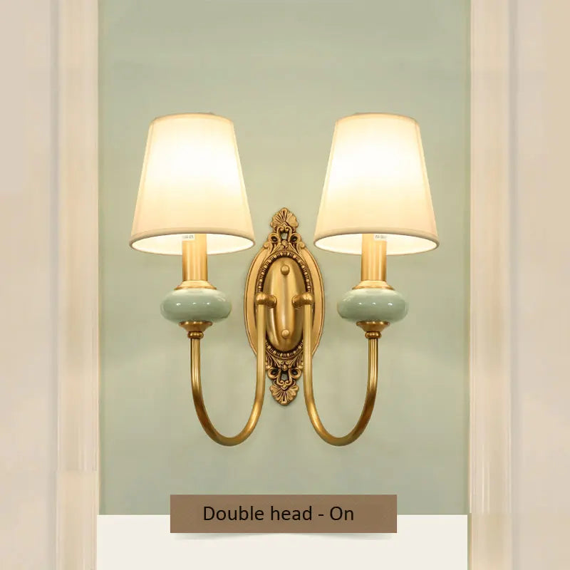 Vintage copper wall lamp emitting warm light in a cozy living room decor