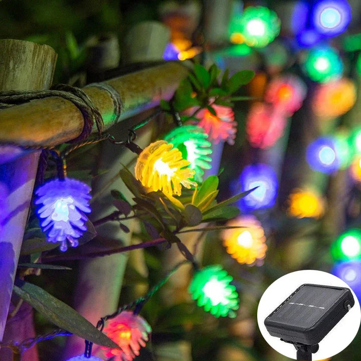 Colorful LED solar string lights wrapped around bamboo in a garden
