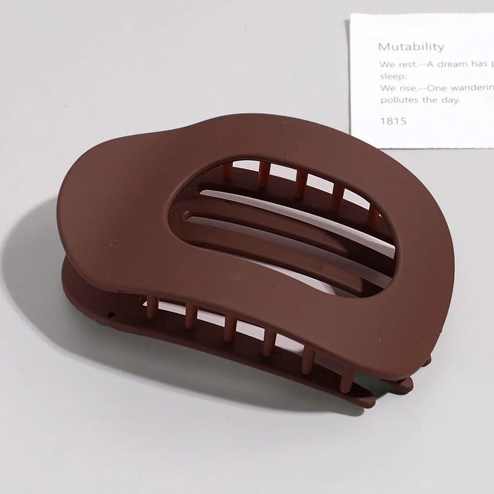 Essential hair styling tool featuring a large flat oval silhouette