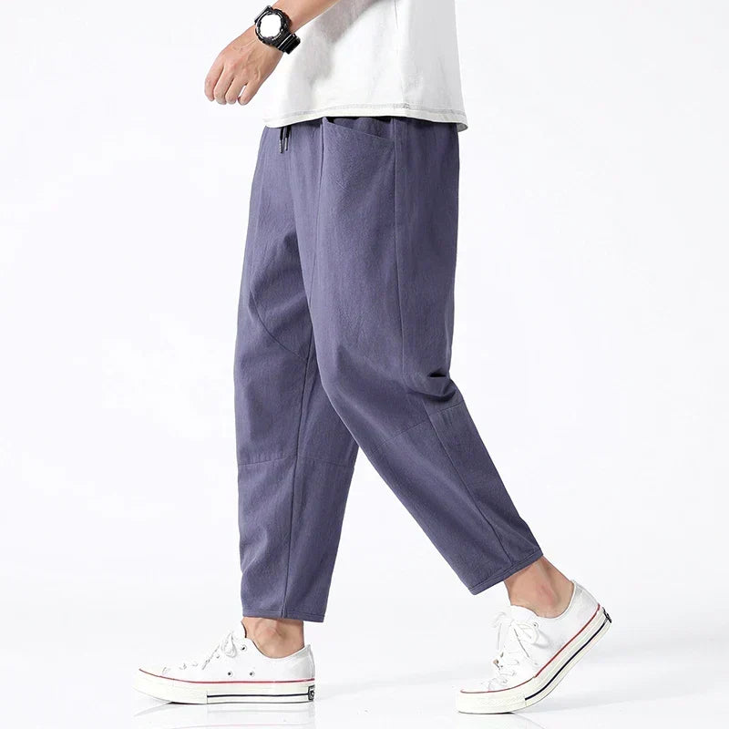 Marcus men's indigo wide leg pants paired with white sneakers and a white t-shirt