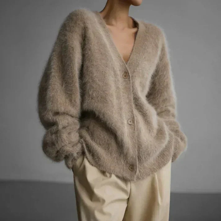Woman wearing a beige relaxed knit cardigan with front buttons