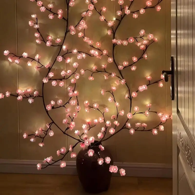 Maplebloom cherry blossom LED string lights arranged in a dark vase against a wall