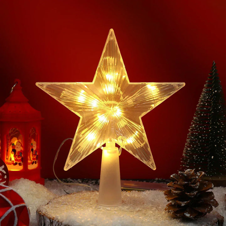 Starlit LED Christmas star topper glowing warmly next to holiday decorations