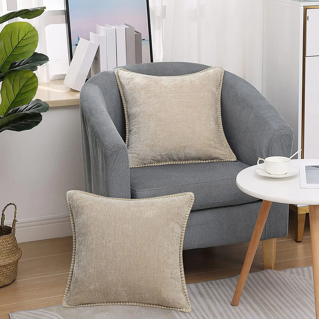 Set of two decorative pillow cases arranged on a minimalist bed