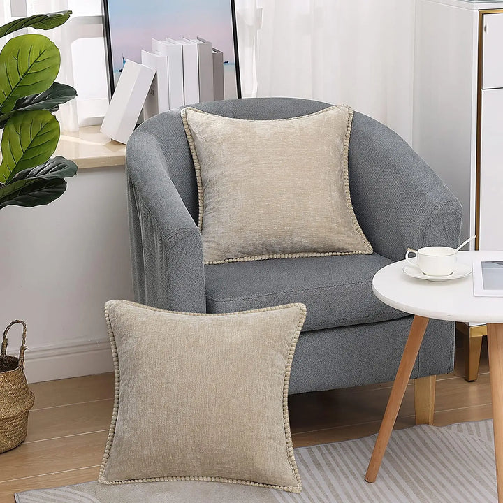 Set of two decorative pillow cases arranged on a minimalist bed