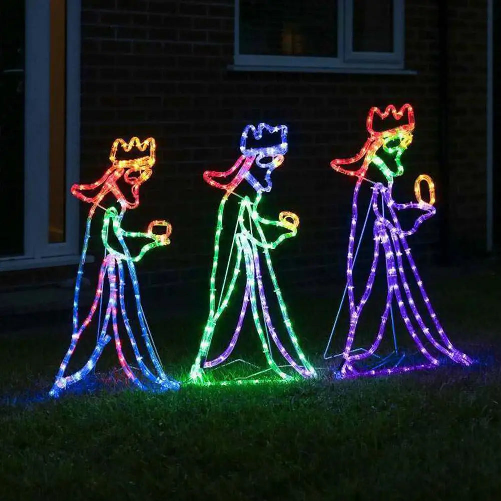Close-up view of the Three Wise Men LED light silhouette glowing against a brick house
