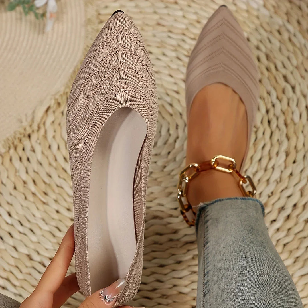 Close-up view of apricot pointed toe knitted ballet loafers being held up showcasing texture