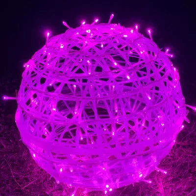 Detailed view of woven wicker ball ornament attached to LED string light cable