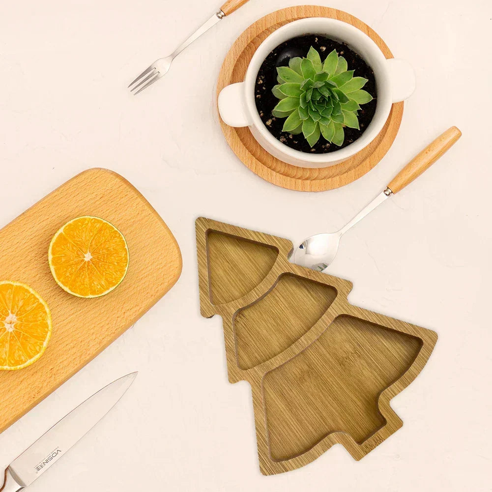Christmas tree wooden serving board styled with holiday appetizers on a festive dining table