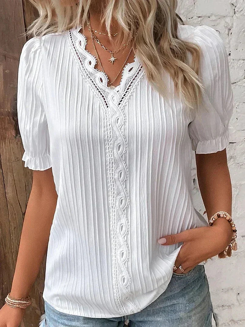 Woman wearing the white Bea elegant blouse with lace trim detailing