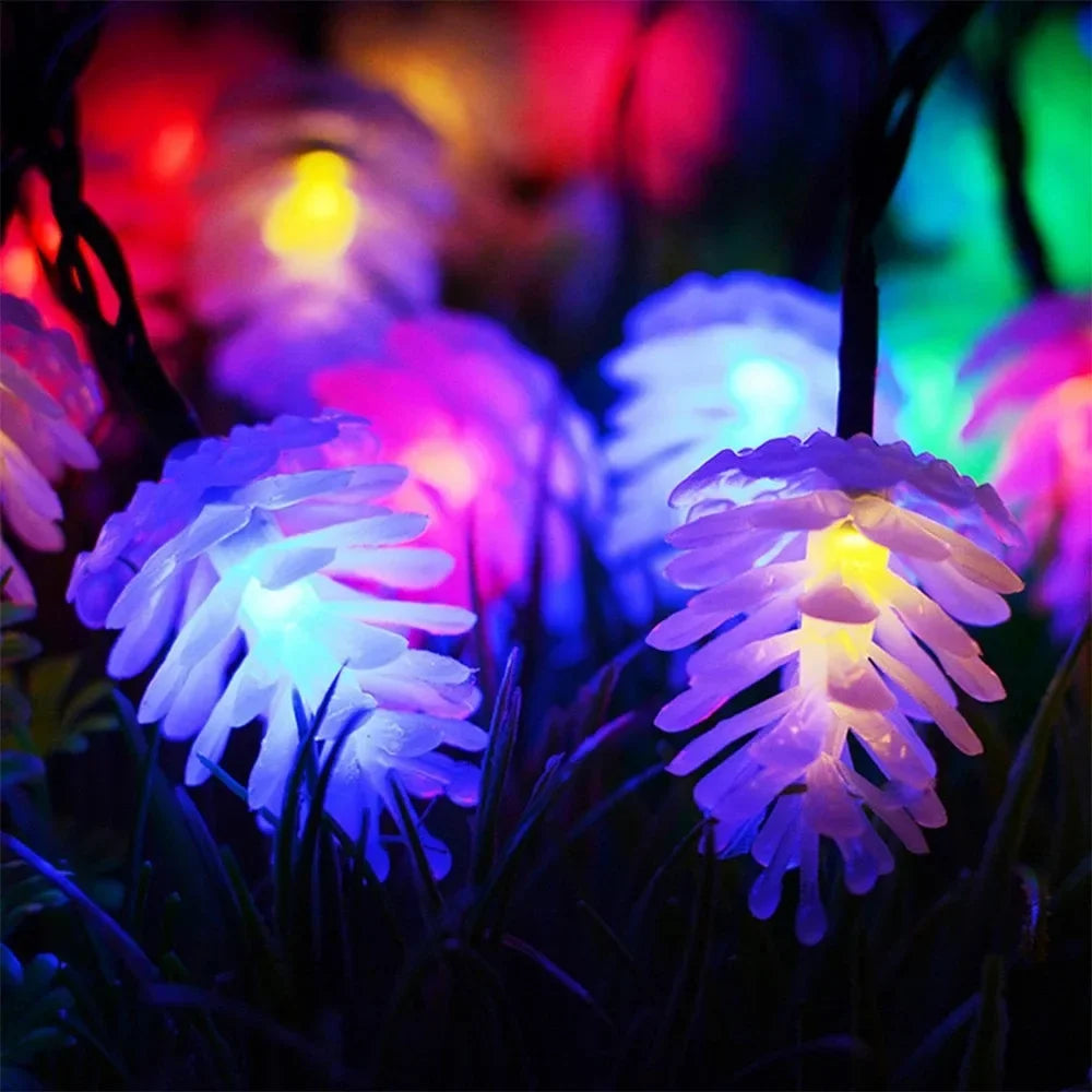 Vibrant multicolored LED pinecone fairy lights glowing in the dark
