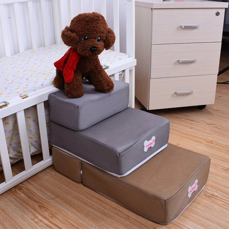 Brown dog climbing grey pet steps next to a white baby crib and dresser