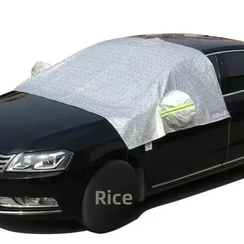 Silver reflective car cover fitted on the front windshield and side mirror of a black saloon car
