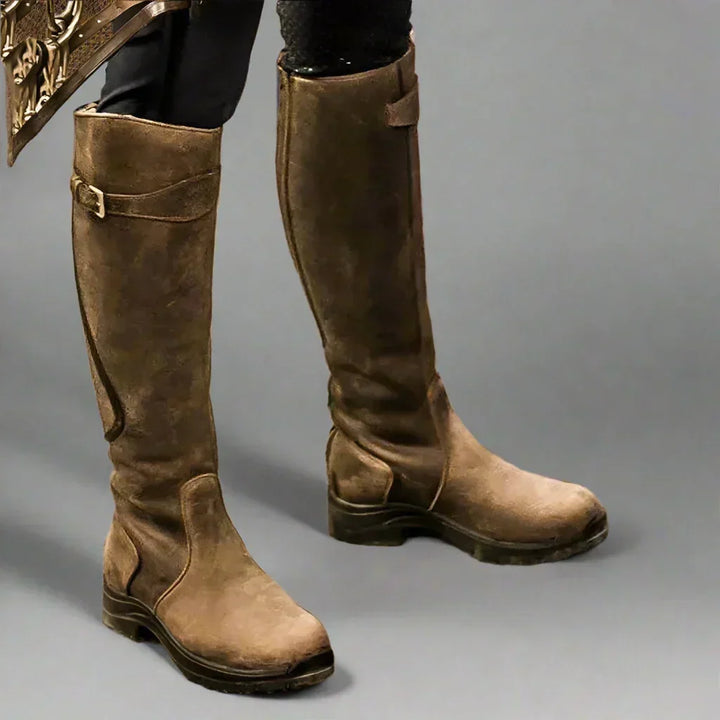 Back view of tall equestrian boots featuring stretch panel for custom fit