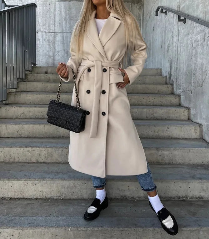 Woman wearing apricot long lapel winter coat with a belted waist