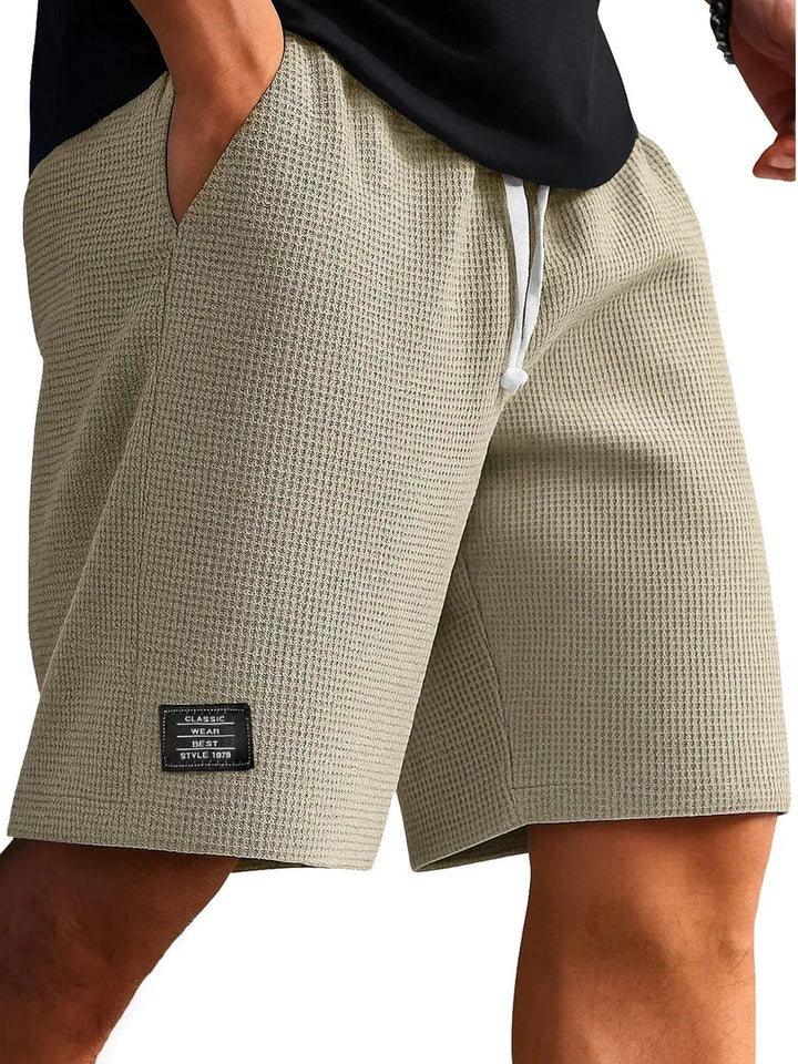 Flat lay of men's activewear shorts displaying versatile summer style