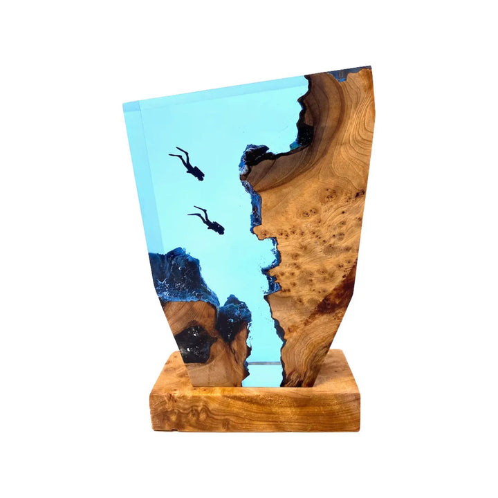 Ocean resin table lamp glowing with warm LED light, highlighting epoxy wave details