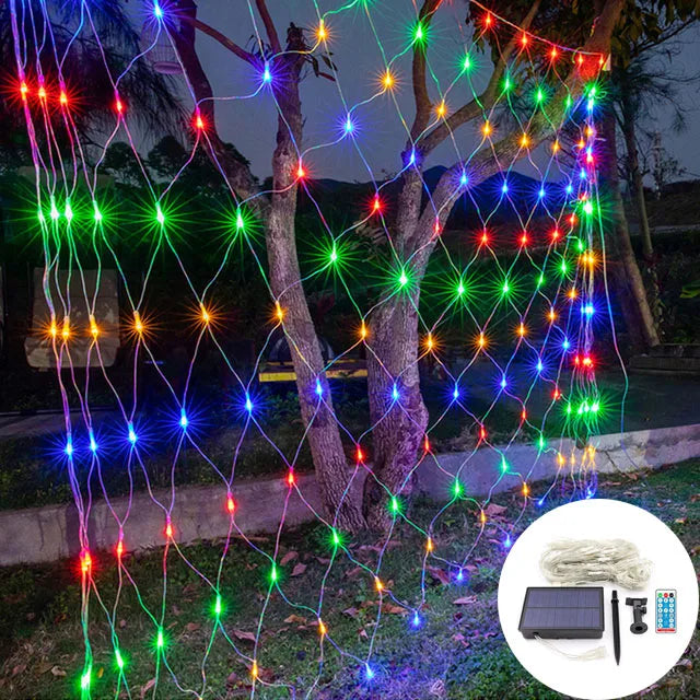 Solar powered patio lighting net spread across a wooden fence outdoors