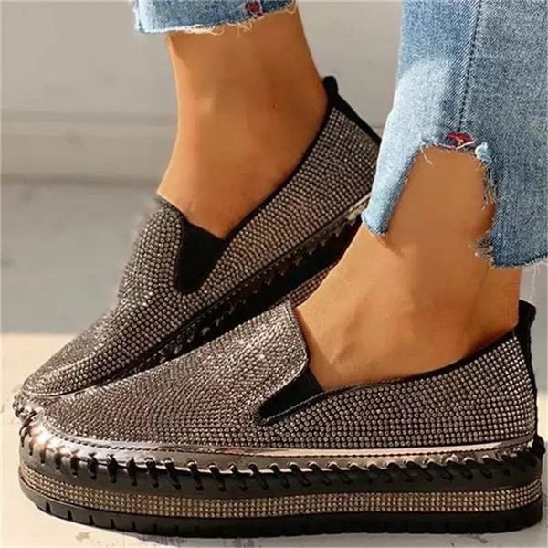 Close-up of black slip-on shoes with decorative upper texture
