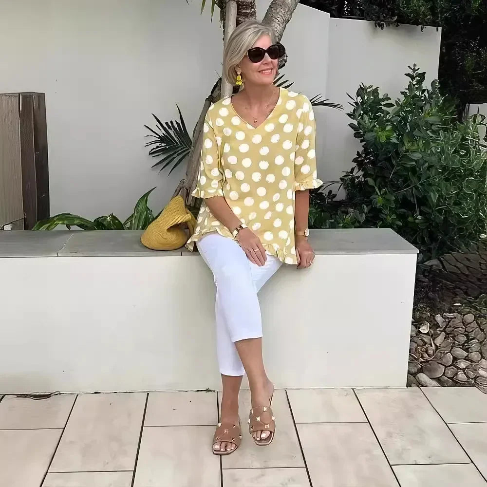Close-up of polka dot blouse pattern on women's V-neck tee