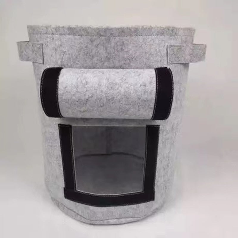 Empty fabric planter bag laid flat to show collapsible design