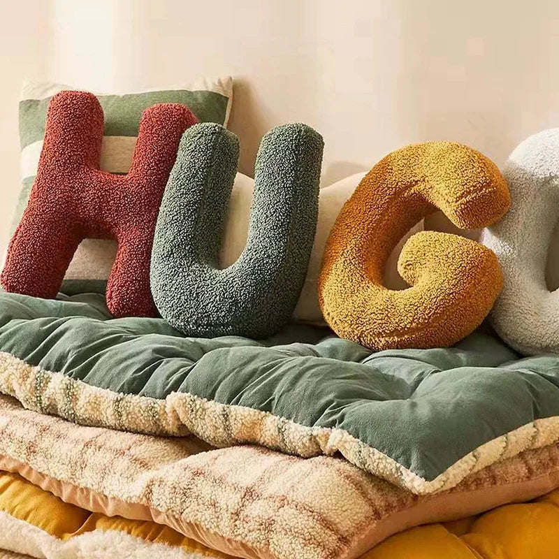 Decorative alphabet cushion letter pillow on bench