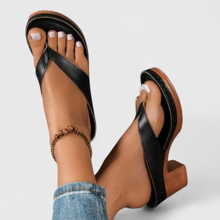 Close-up of black Talia block heel thong sandal worn on foot