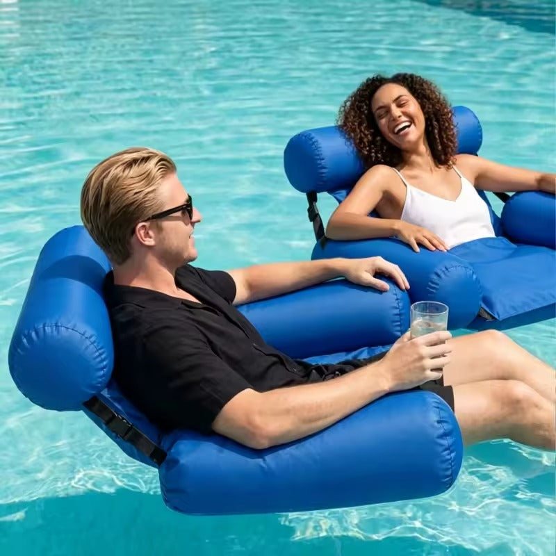 Man and woman relaxing side by side on blue inflatable water chairs in a pool