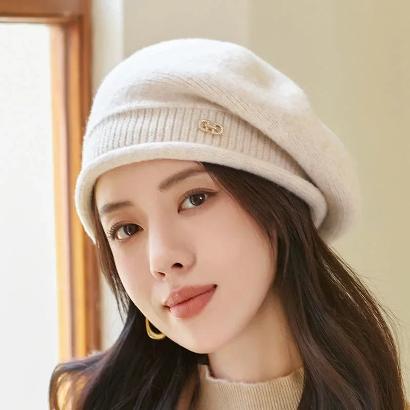 Woman wearing a cream beige knit winter beret hat