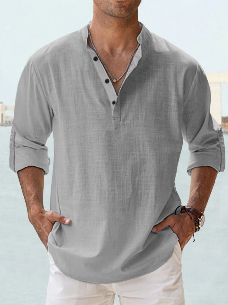 Man wearing a gray button-up shirt with button detailing