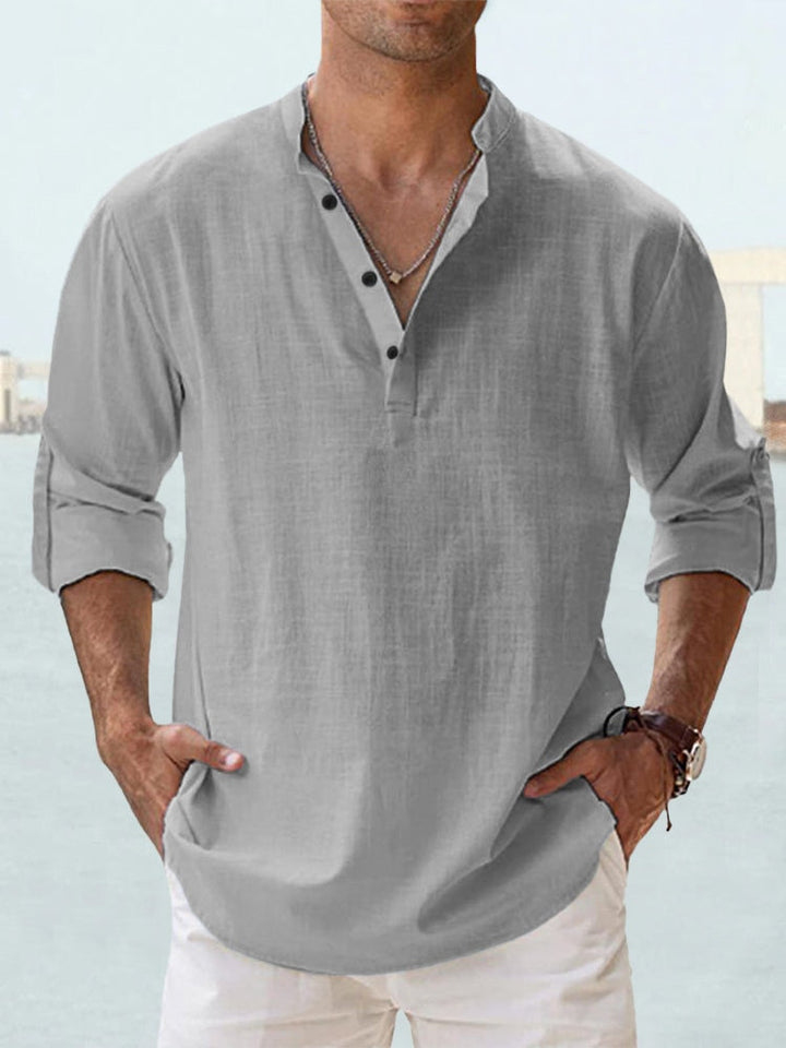 Man wearing a gray button-up shirt with button detailing
