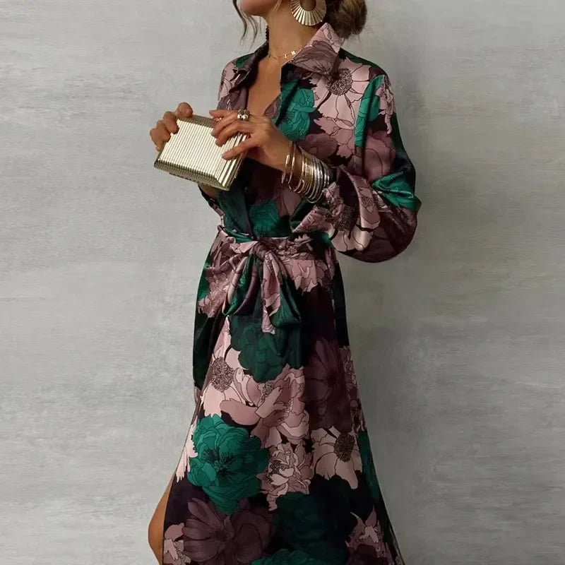 Woman wearing dark green floral maxi dress with belt holding a clutch