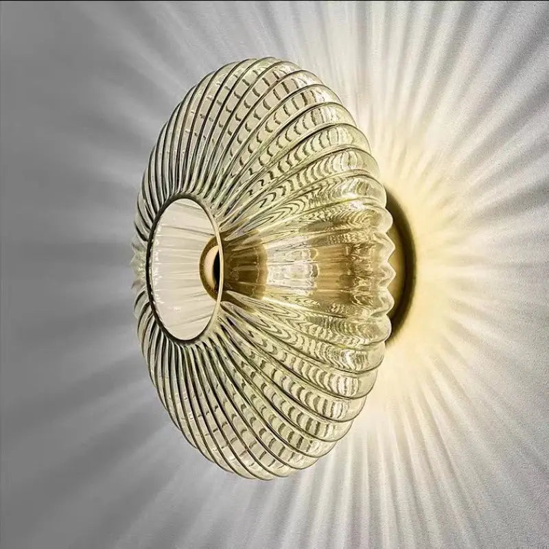 Nordic glass wall lamp in cognac finish mounted on a textured grey wall