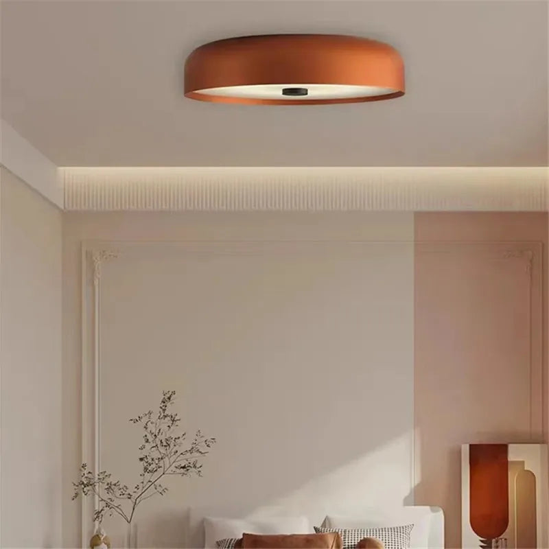 Modern minimalist LED ceiling light fixture illuminated in a contemporary living room.