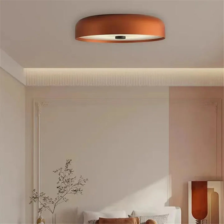 Modern minimalist LED ceiling light fixture illuminated in a contemporary living room.