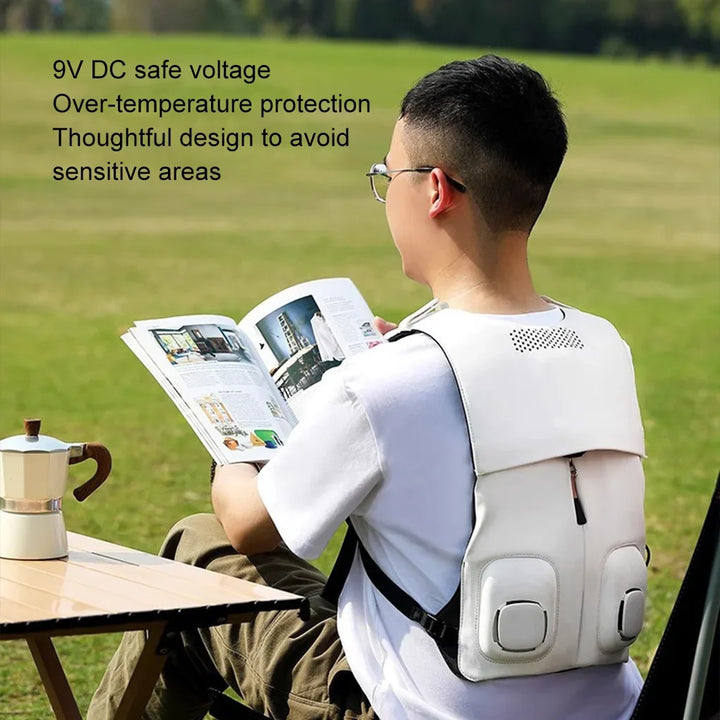 Person wearing white cooling vest outdoors reading a book