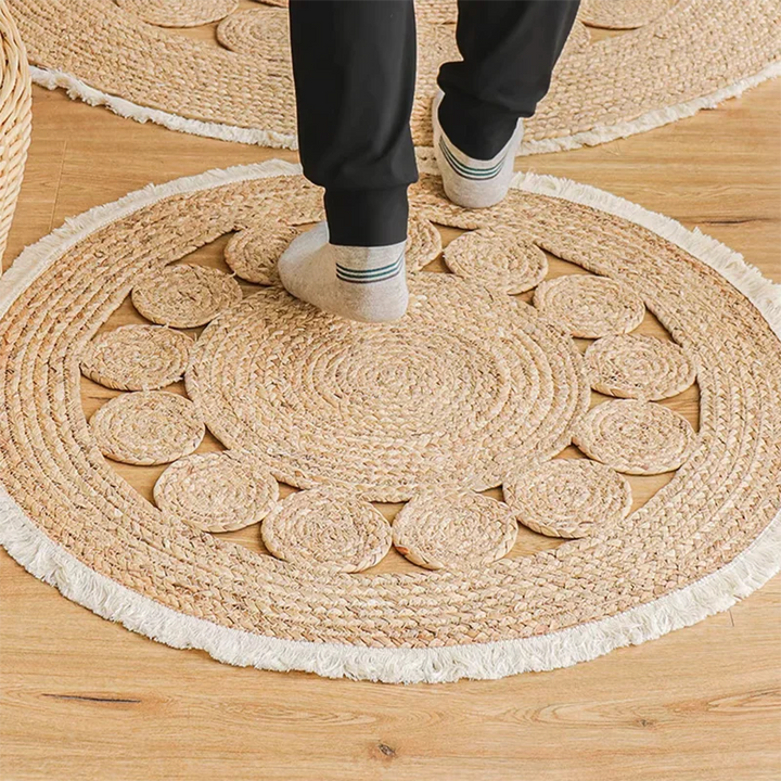 EcoStep round woven rug on wooden floor with feet showing texture