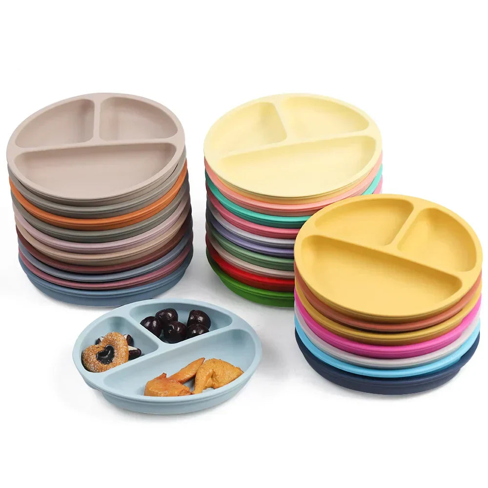 Assorted colorful silicone divided plates stacked together