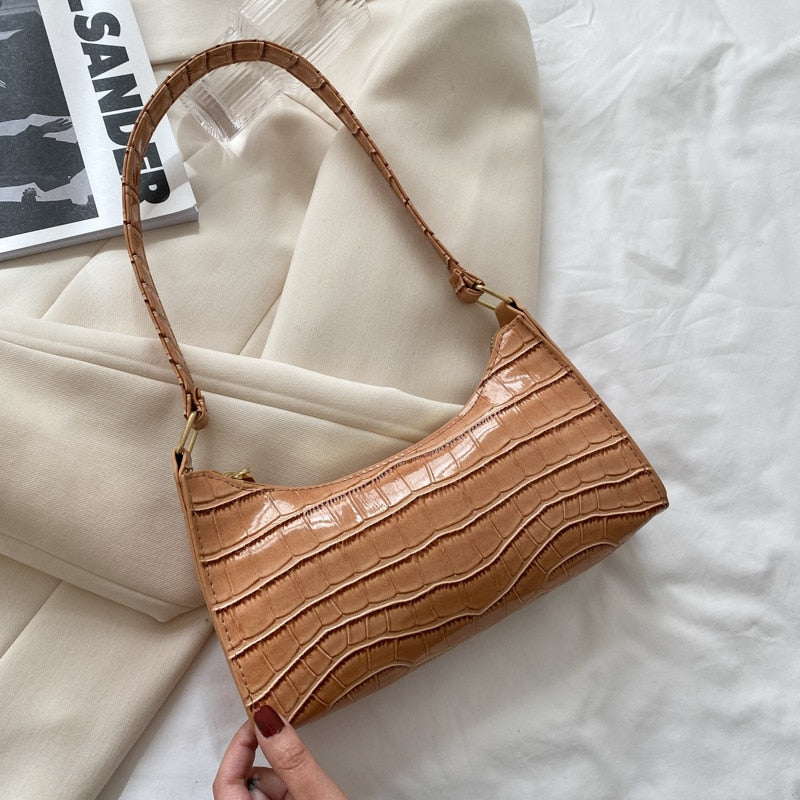 Hanging shot of chic women's handbag highlighting comfortable drop handle