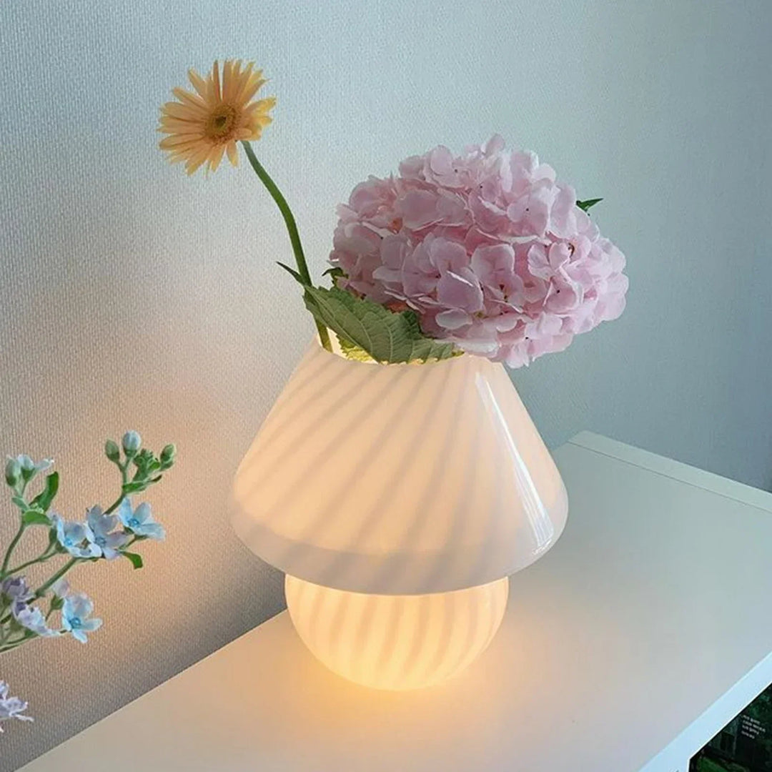 Pink glass mushroom table lamp styled elegantly as a decorative vase with fresh flowers