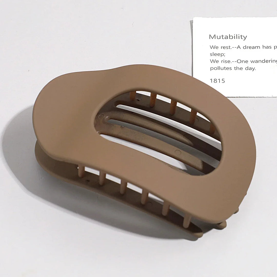 Close-up view of the sturdy spring mechanism on a large hair claw clip