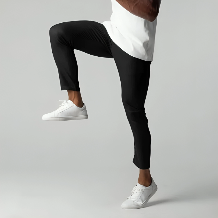 Man demonstrating flexibility in black stretch chino trousers