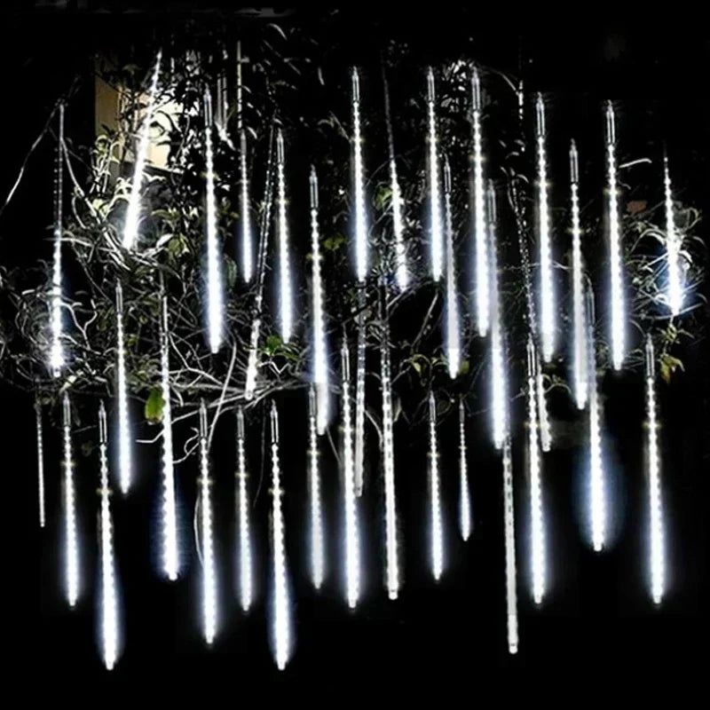 White LED meteor shower light tubes hanging in a tree