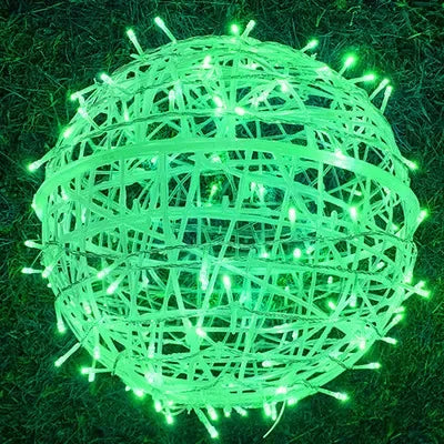 Festive rattan string lights casting a warm glow on a backyard patio fence