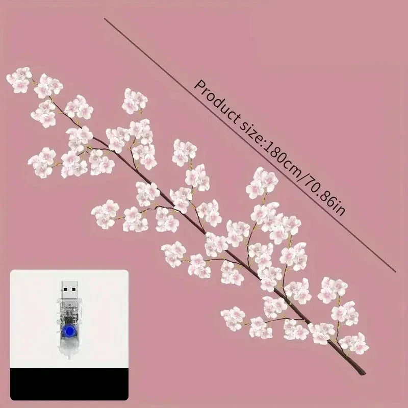 Close up of delicate cherry blossom flower fairy lights featuring bright LED bulbs for room decoration